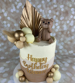 2 tier 2 toned cute birthday cake with teddy bear and gold palm spear