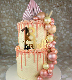2 tier buttercream birthday cake with a pink drip and dried flowers