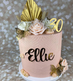 pink buttercream birthday cake with dried flowers