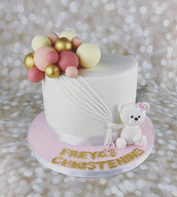 single tier christening cake with bear model and balloons