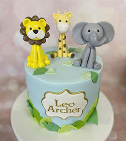 2 tier naming day cake with jungle themed models