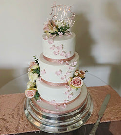 3 tier wedding cake with butterflies and flowers