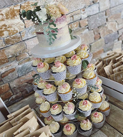 single tier naked wedding cake with cupcake tower