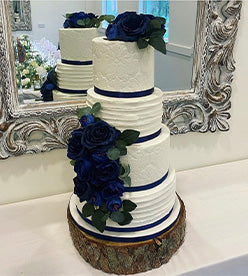 4 tier wedding cake with dark blue flowers